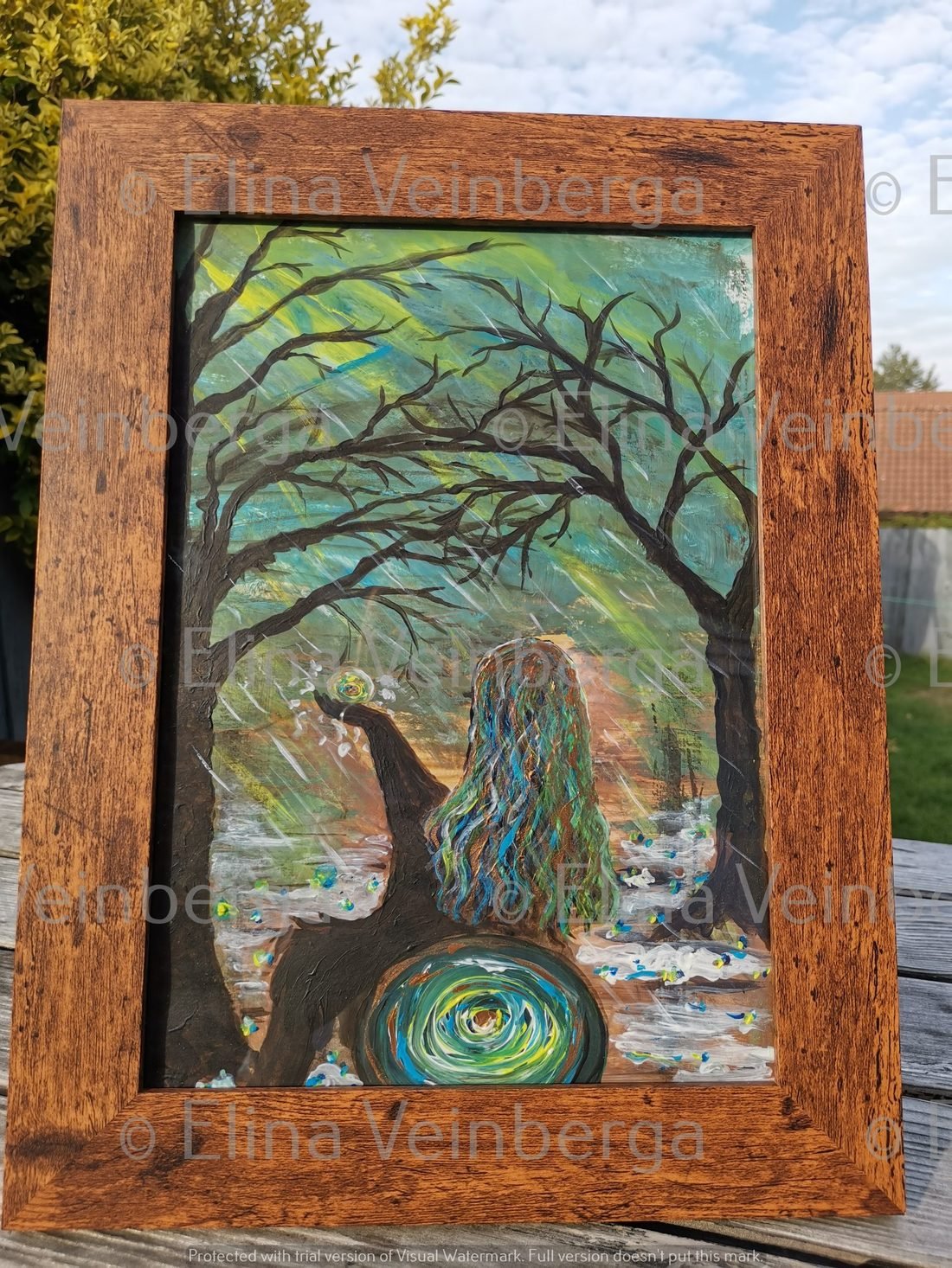 Acrylic painting of a woman beneath a tree, framed in wood